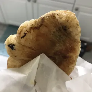 a hand holding a piece of bread
