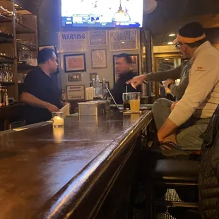 two men sitting at a bar