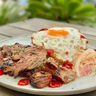 TAPSILOG garlic rice. free range fried egg. marinated sirloin, banana ketchup.