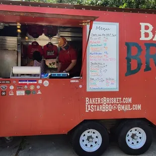 a woman standing in front of a food truck