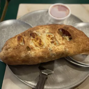 It looks small in this photo, but I assure you it was huge!!  Calzone with bacon, sausage, and pepperoni