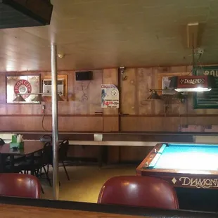 Bar area has a pool table and shuffleboard table
