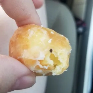 a hand holding a doughnut