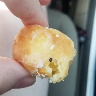 a hand holding a half eaten doughnut