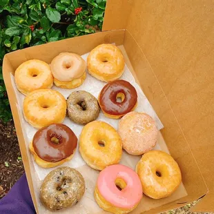 Variety box with glaze, maple, strawberry, chocolate, and blueberry cake donut