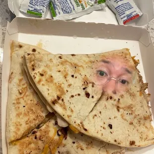 a man's face on a quesadilla