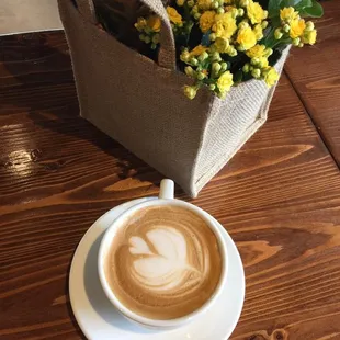 a cup of coffee and a bag of flowers