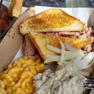 Sliced brisket and pulled pork plate with mac and cheese and potato salad