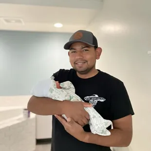 A new father holding his first born.