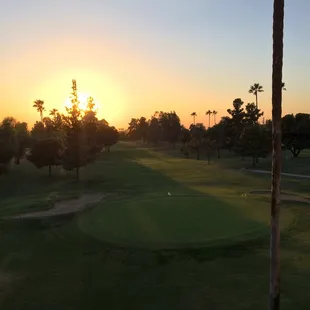 a golf course at sunset