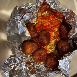 Thai chili boneless wings. White chicken and crunchy cooked perfect! This sauce is amazing not spicy but very flavorful.