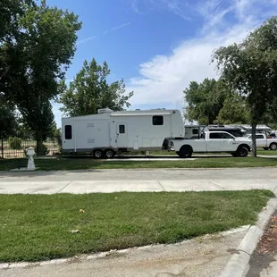 Mature trees and well maintained grass between sites