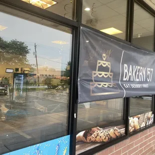 a bakery window with a banner on it