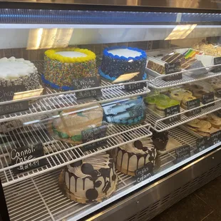 a display case with a variety of baked goods