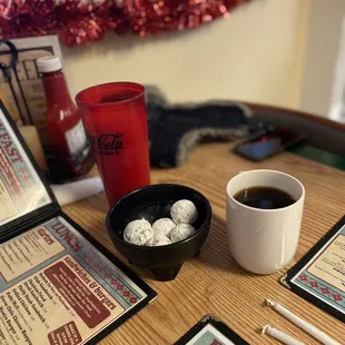menus, coffee, donuts, and a cup of coffee