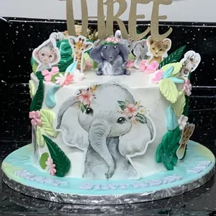 a cake decorated with animals and flowers