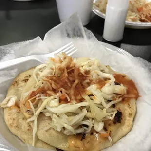 a tortilla with shredded cheese and onions