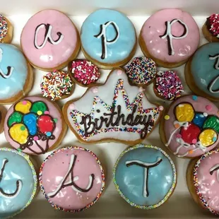 a box of decorated birthday cookies