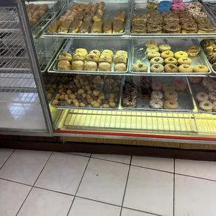 a variety of donuts in a display case