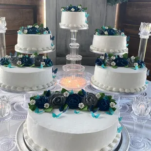 a wedding cake with blue flowers