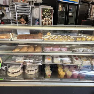 a woman behind a bakery counter