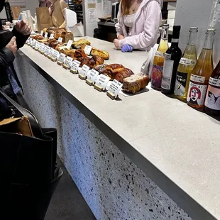 a woman ordering pastries at a counter