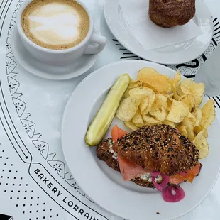Latte, salmon sandwich on everything croissant and a pastry