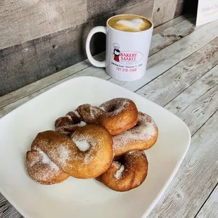 ows a plate of doughnuts and a cup of coffee