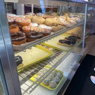 a variety of donuts in a display case