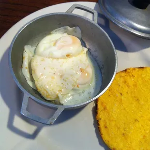 Huevos en cacerola. Eggs poached in this little pot. $3.99