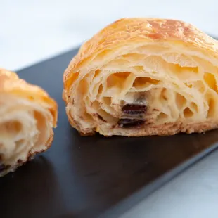 a croissant pastry on a black plate