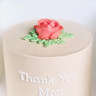 Guava Cheese Celebration Cake (small) with smooth custom color base, fondant lettering, and buttercream rose.