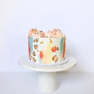 Strawberry Pistachio Celebration Cake (small) with abstract brush strokes, gold leopard print, and buttercream kisses.