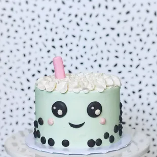 Cereal Milk Celebration Cake (small) with boba character design. Chocolate detailing + fondant straw.