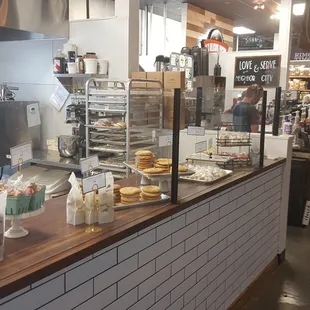 a bakery counter with a variety of baked goods