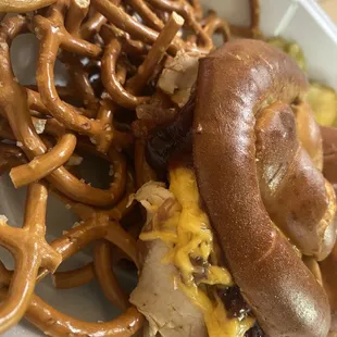 a sandwich and pretzels in a styrofoam container