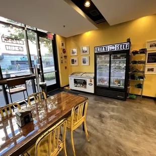 a table and chairs in front of a refrigerator