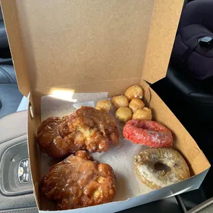 Apple fritters, blueberry and strawberry donuts, glazed holes