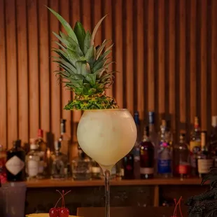 a pineapple cocktail with a pineapple garnish