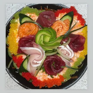 a platter of sushi and vegetables