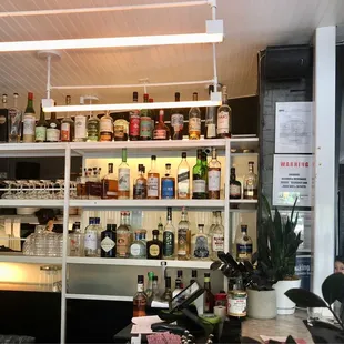 a bar with shelves full of alcohol bottles