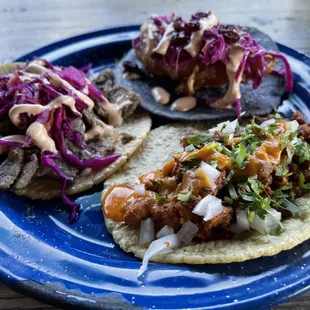 two tacos on a blue plate