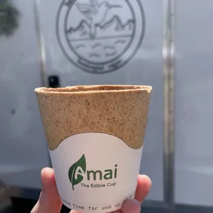 a hand holding a cup of coffee