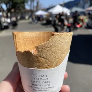 a hand holding a paper cone