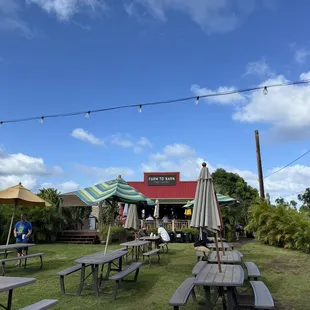 a picnic area with tables and umbrellas