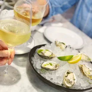 a plate of oysters and a glass of wine