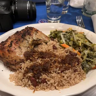 a plate of rice, meat and vegetables