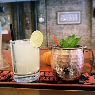 two cocktails on a bar