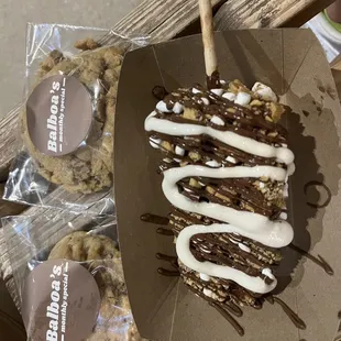 Chocolate dipped cheesecake with the &quot;campfire&quot; toppings (mini marshmallows, graham cracker, Nutella drizzle, and marshmallow drizzle).