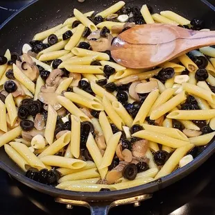 a skillet of pasta and mushrooms